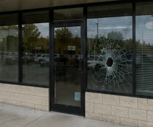 Broken storefront glass before replacement
